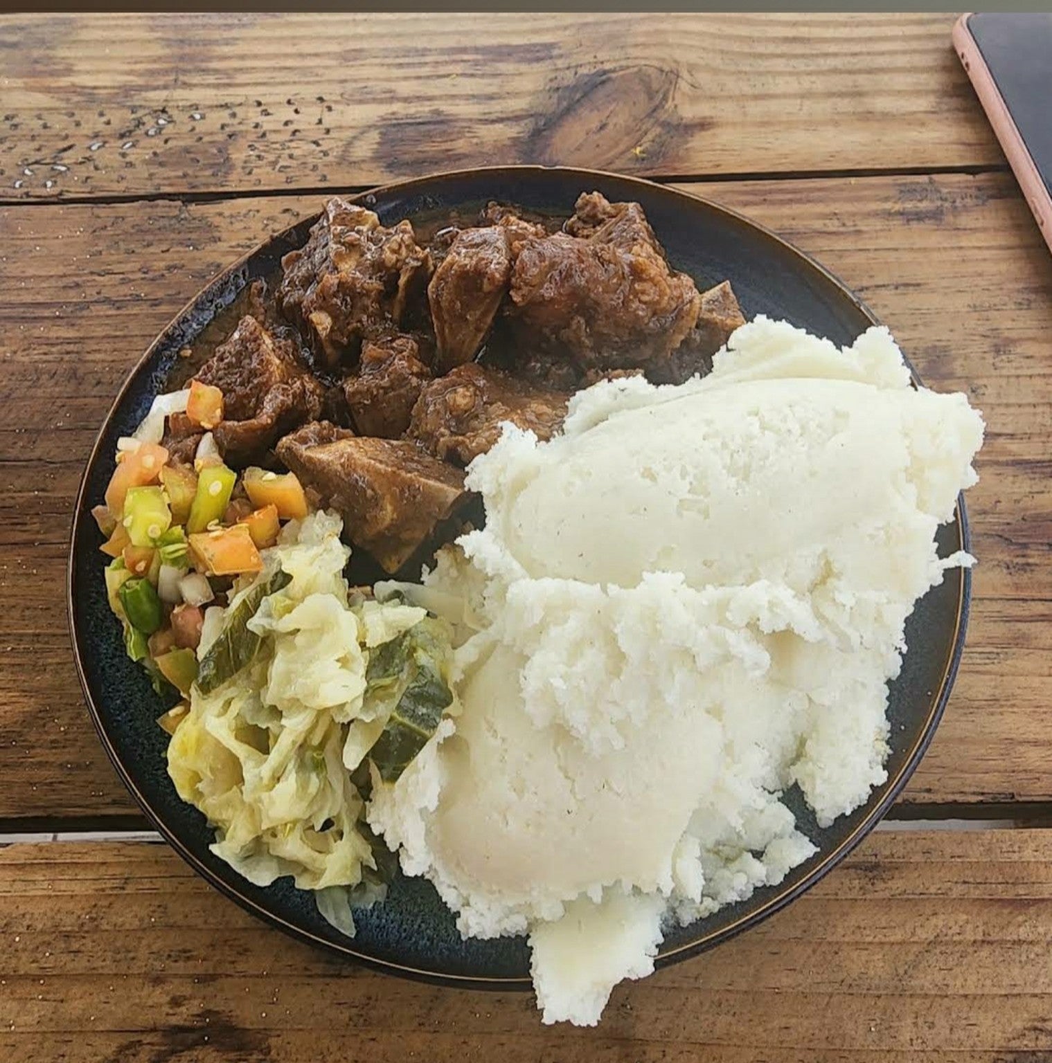 Traditional meat plate served with pap and salads at Phala's Eating House